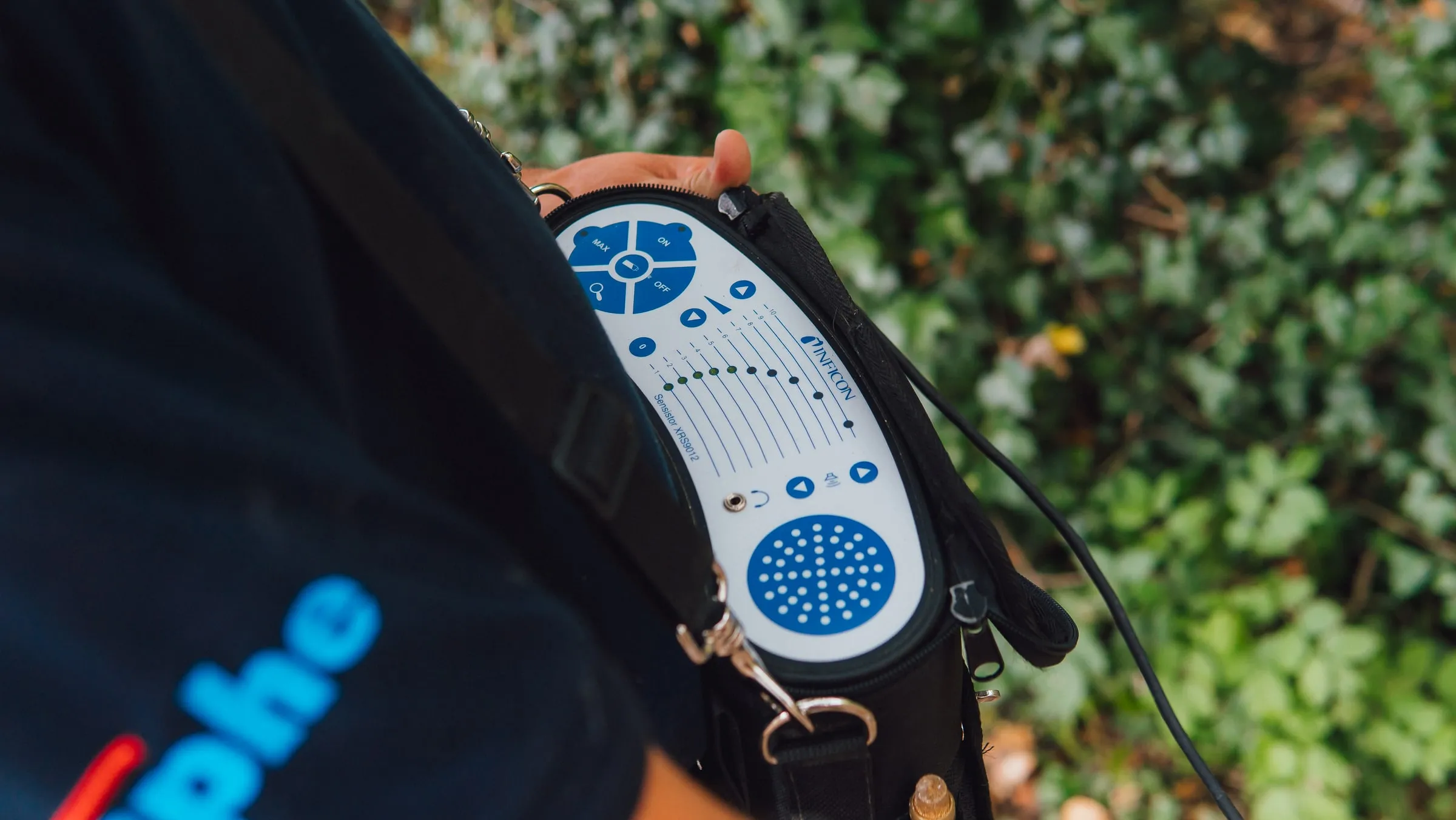 Acoustic listening unit carried on an engineer's shoulder strap, with its control panel facing up
