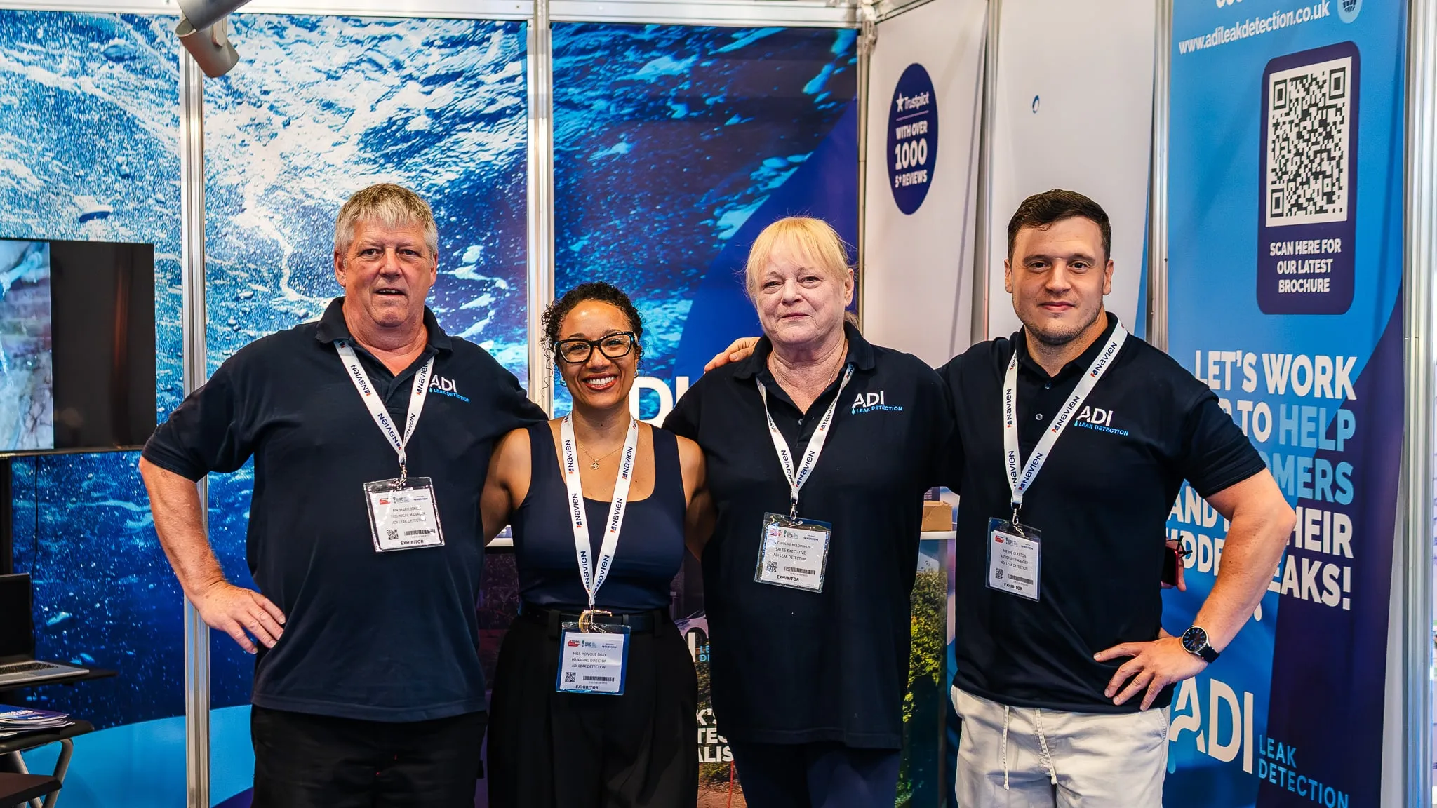 Four members of the ADI Leak Detection team standing together at the company's exhibition stand